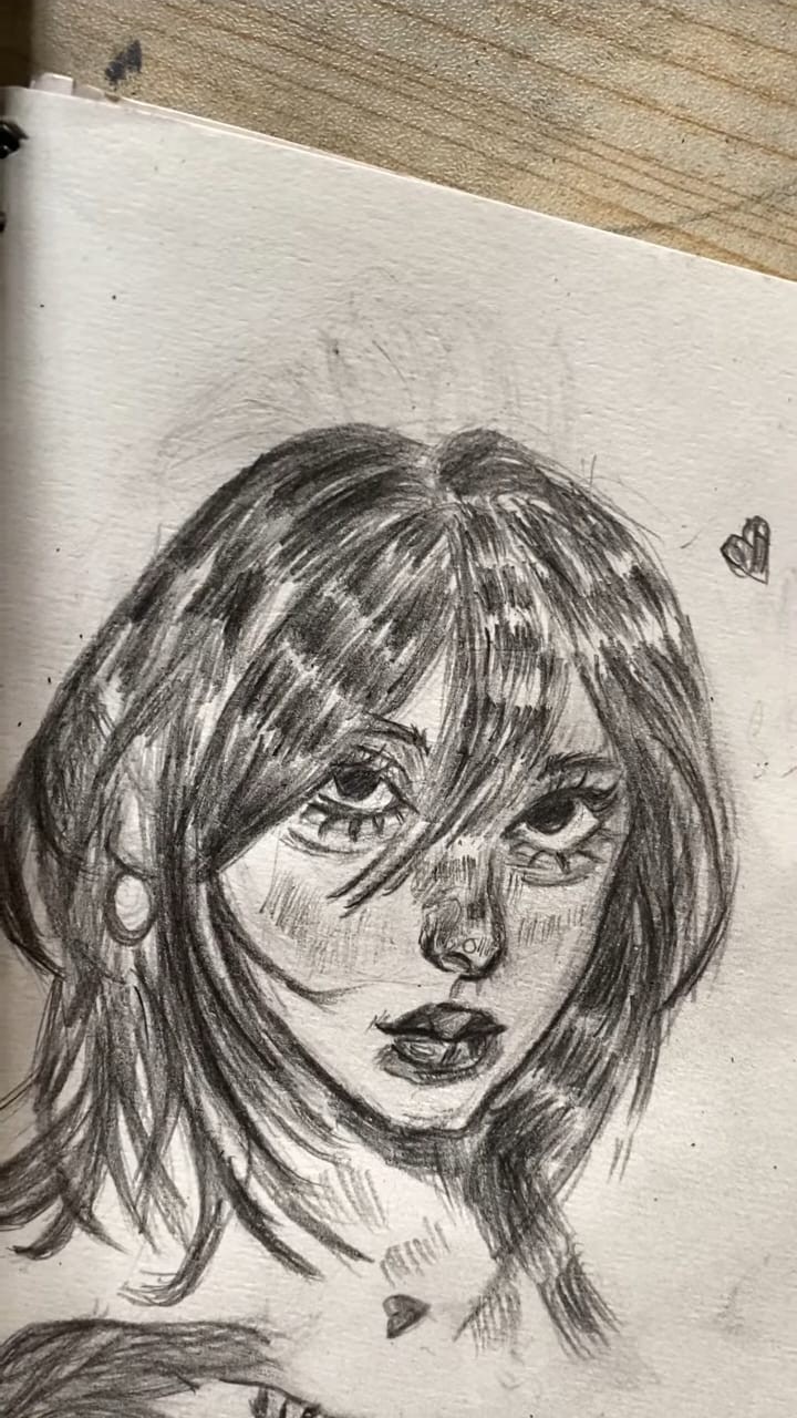 Pencil portrait sketch of a girl with layered bangs, graphite on sketchbook paper